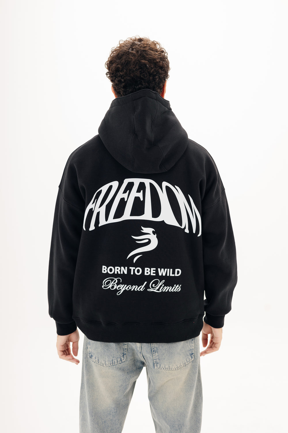 Unisex black hoodie with Beyond statement DTF back print by BLANCKA — on model
