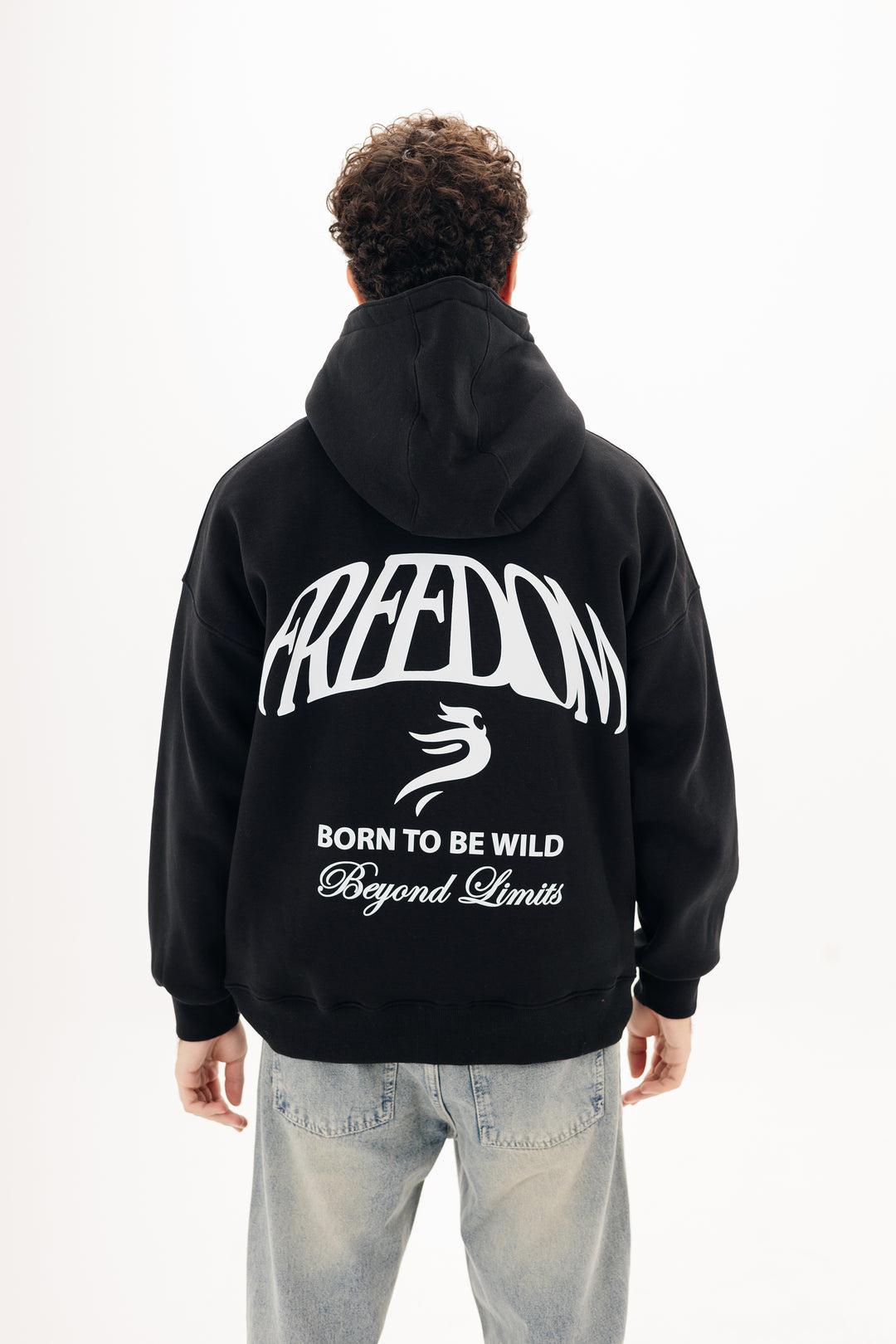 Unisex black hoodie with Beyond statement DTF back print by BLANCKA — on model
