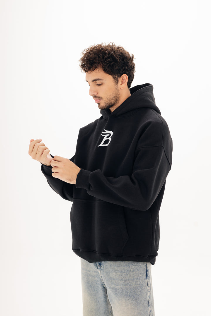 Unisex black hoodie with Beyond statement DTF back print by BLANCKA — on model
