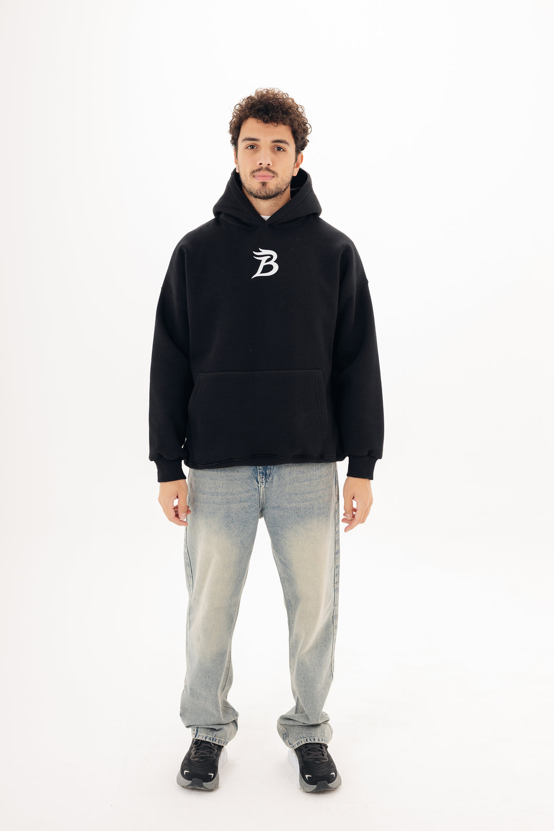 Unisex black hoodie with Beyond statement DTF back print by BLANCKA — on model
