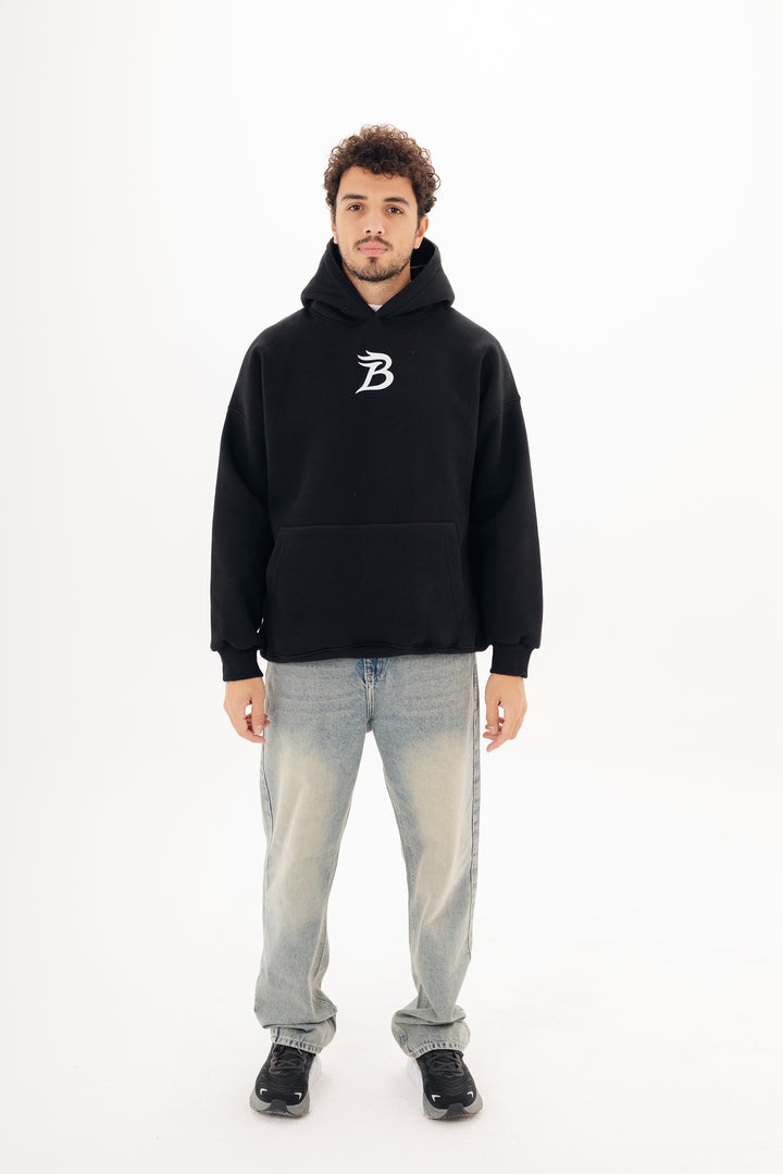 Unisex black hoodie with Beyond statement DTF back print by BLANCKA — on model
