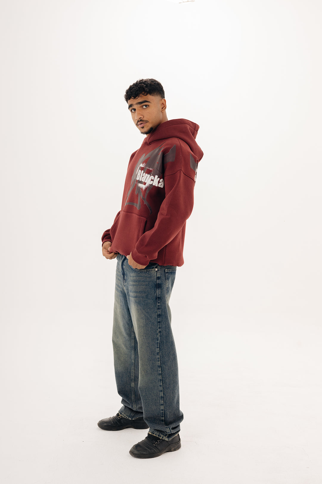 Unisex burgundy hoodie with statement graffiti DTF print by BLANCKA — front and back view on model
