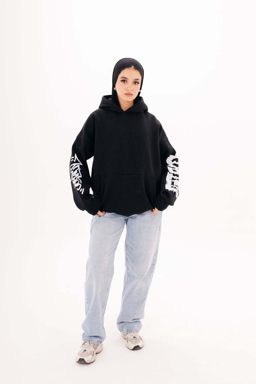 Unisex black graffiti hoodie with white DTF print by BLANCKA — side and back view on model

