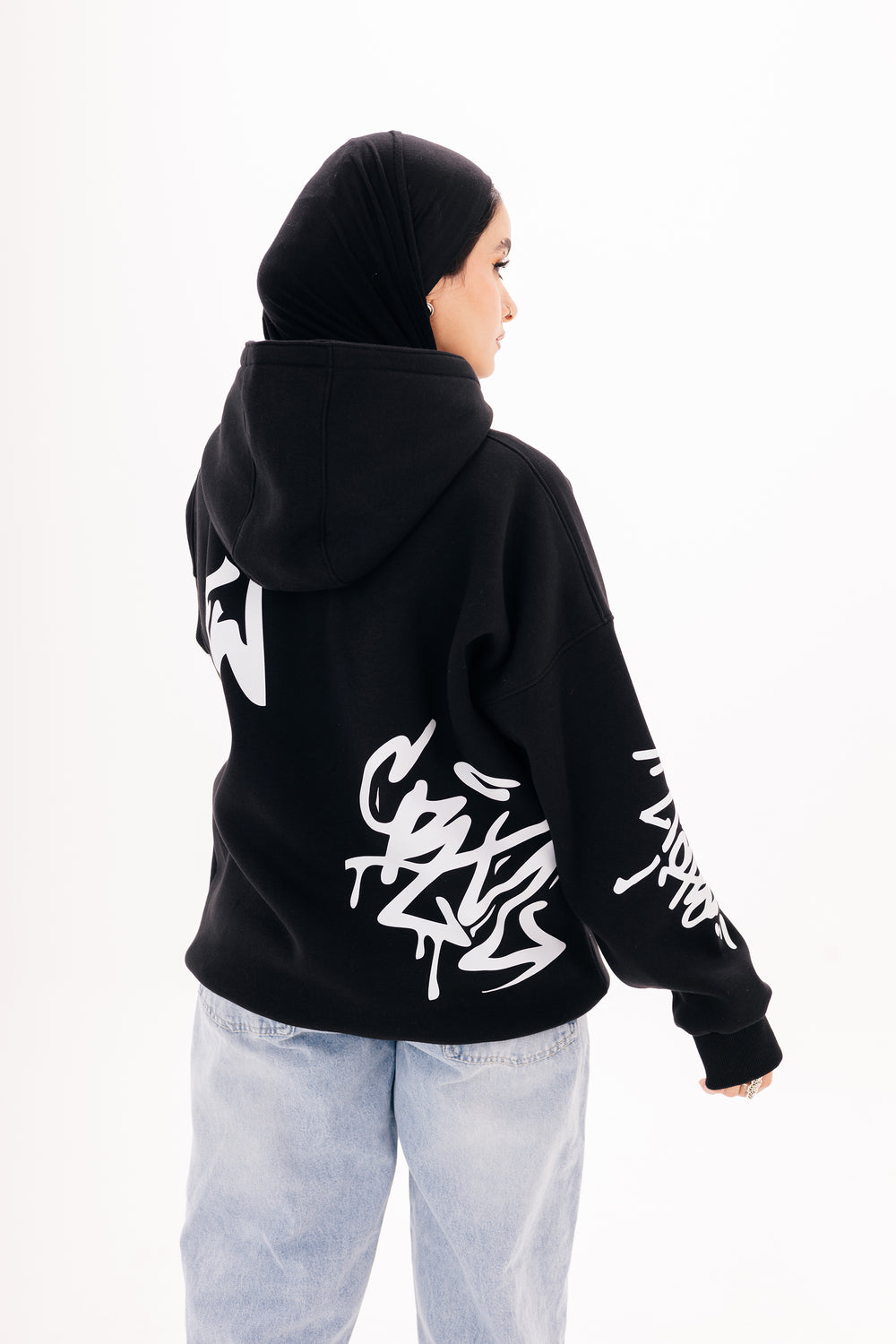 Unisex black graffiti hoodie with white DTF print by BLANCKA — side and back view on model
