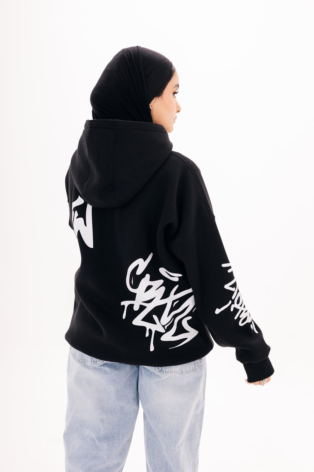 Unisex black graffiti hoodie with white DTF print by BLANCKA — side and back view on model
