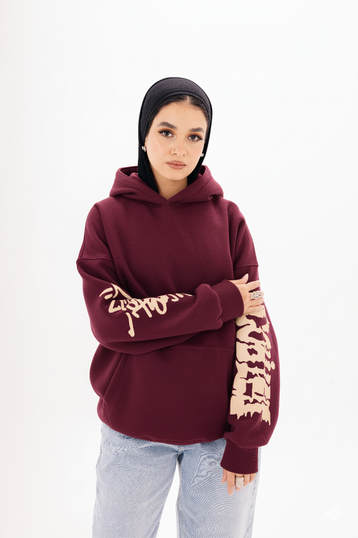 Unisex burgundy graffiti hoodie with white DTF print by BLANCKA — on model
