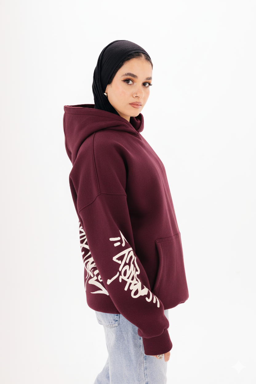 Unisex burgundy graffiti hoodie with white DTF print by BLANCKA — on model
