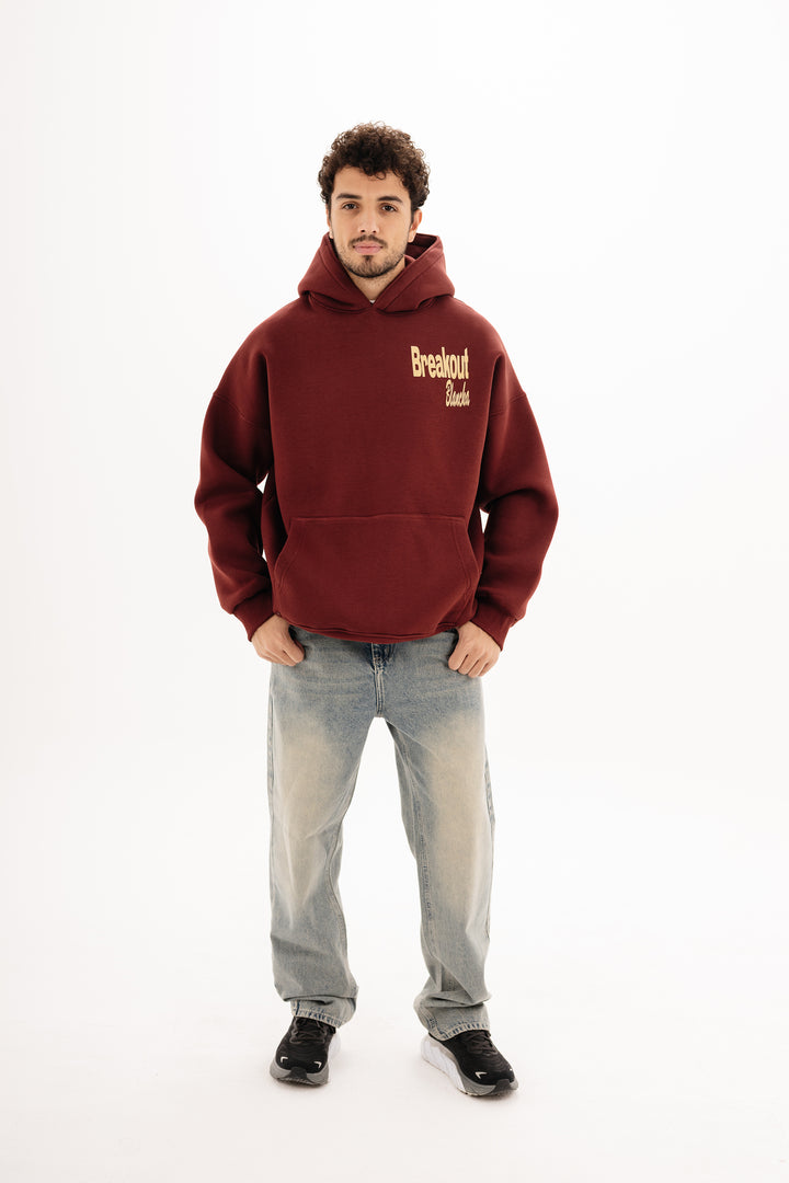 Unisex burgundy hoodie with DTF front and back print by BLANCKA — on model
Back view burgundy hoodie with built beyond graphic — on model
