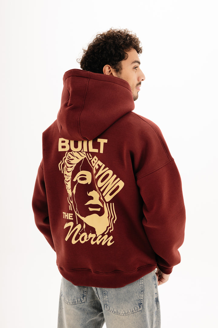Unisex burgundy hoodie with DTF front and back print by BLANCKA — on model
Back view burgundy hoodie with built beyond graphic — on model
