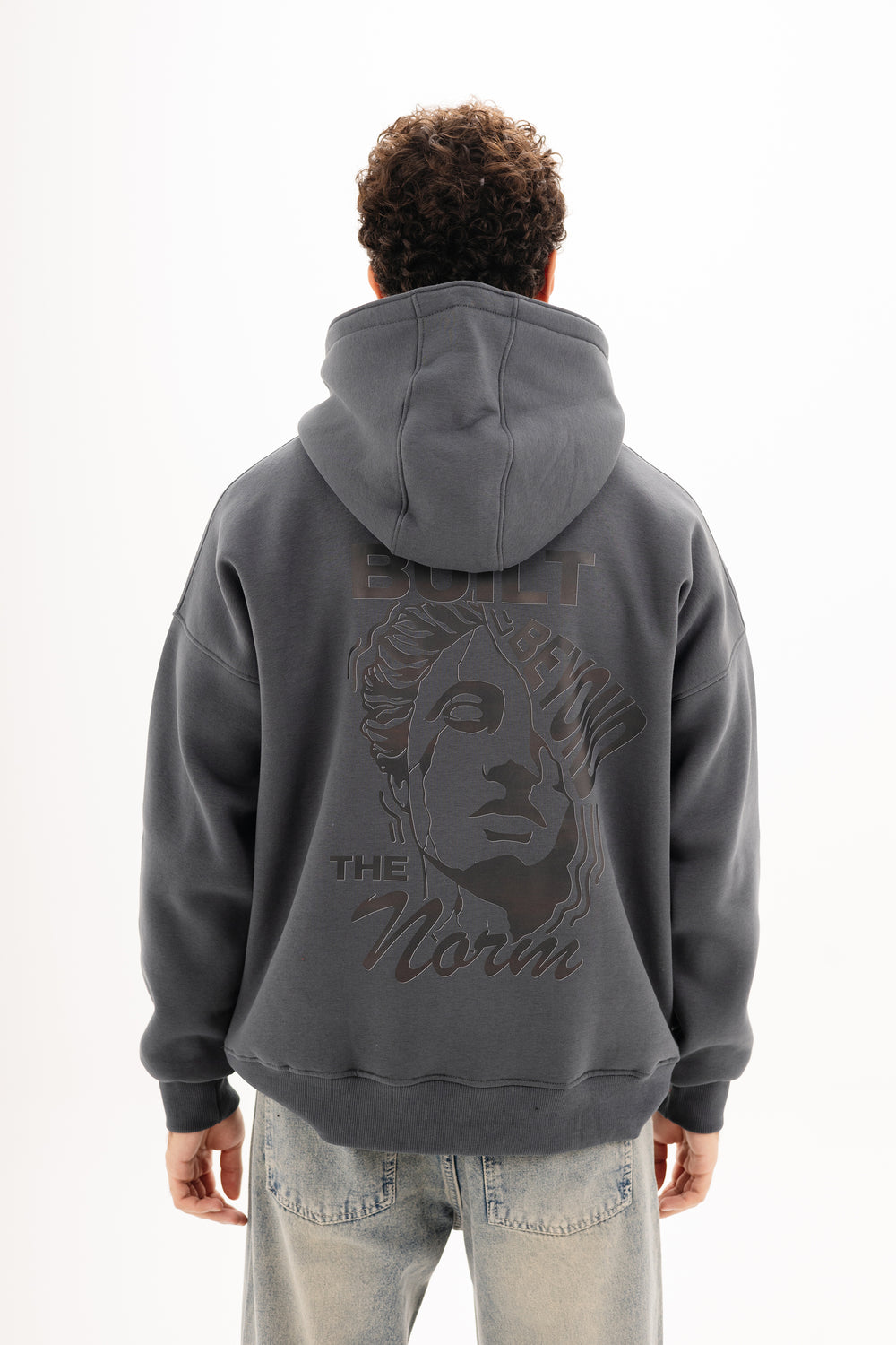 Unisex grey hoodie with black built beyond graphic by BLANCKA — front view on male model
Unisex grey hoodie with large back DTF print — back view on model

