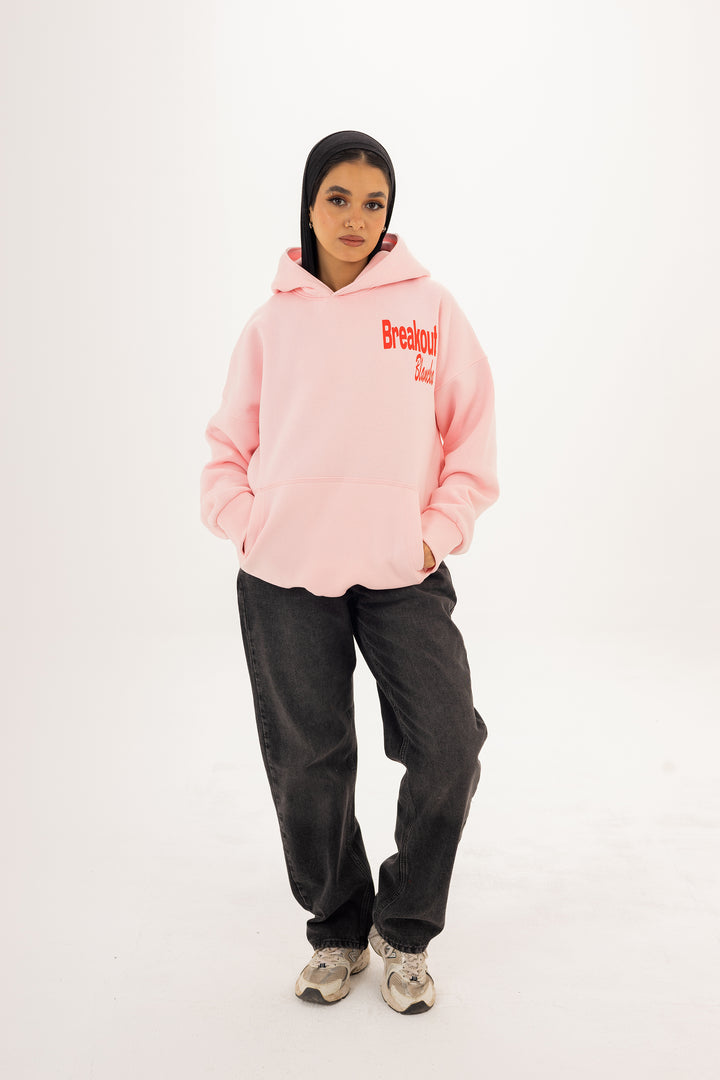 Unisex pink hoodie with front and back DTF graphic by BLANCKA — on model
