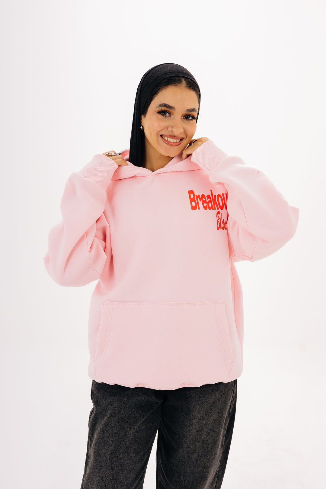 Unisex pink hoodie with front and back DTF graphic by BLANCKA — on model
