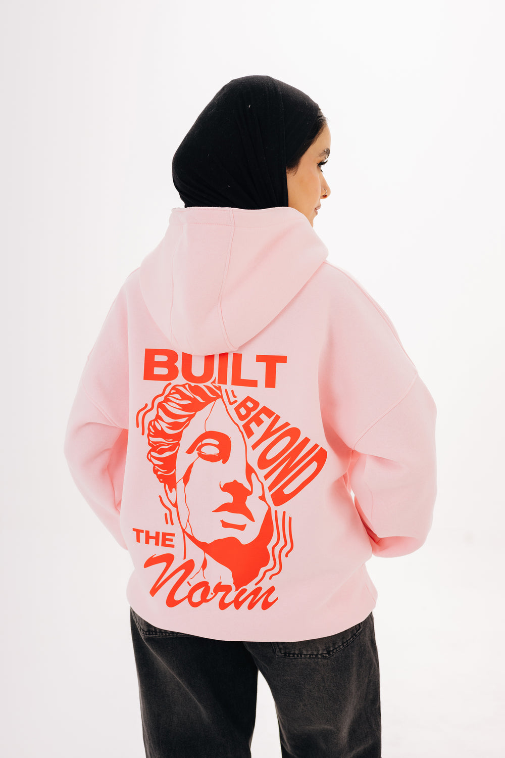Unisex pink hoodie with front and back DTF graphic by BLANCKA — on model
