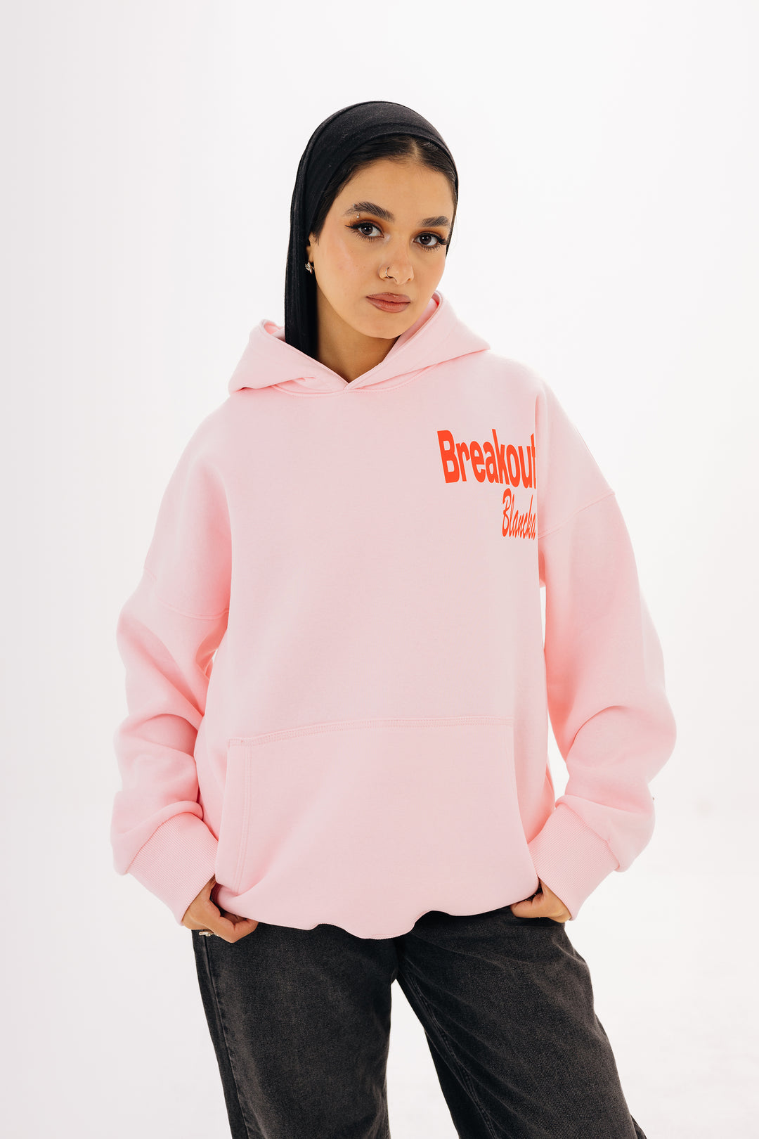 Unisex pink hoodie with front and back DTF graphic by BLANCKA — on model
