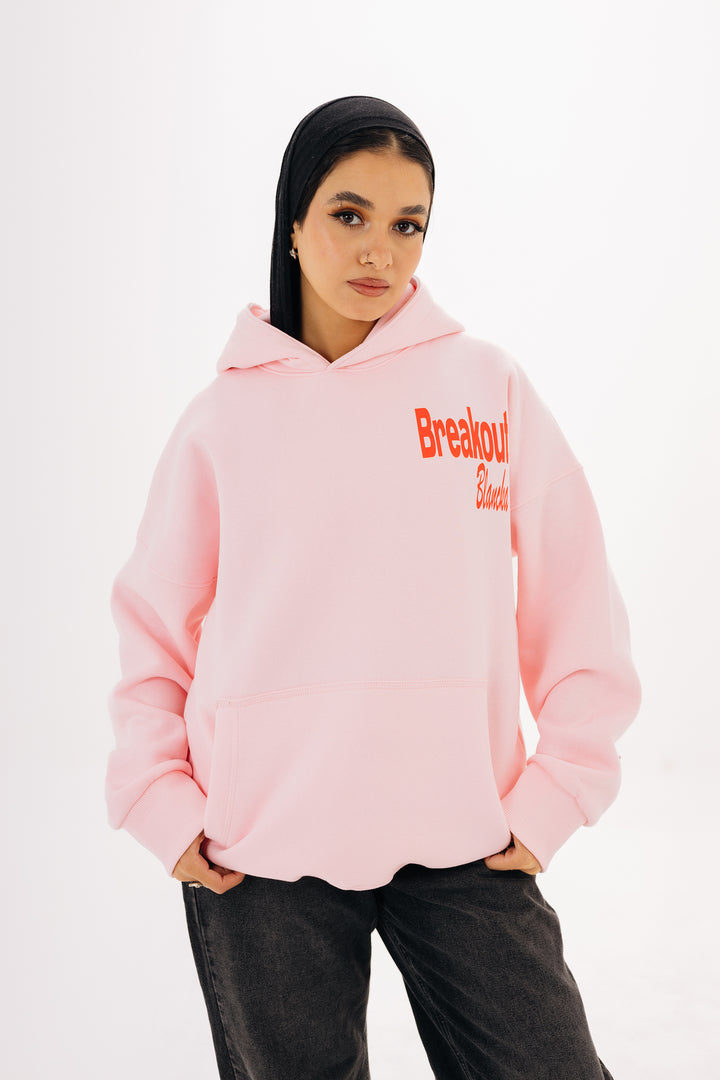 Unisex pink hoodie with front and back DTF graphic by BLANCKA — on model
