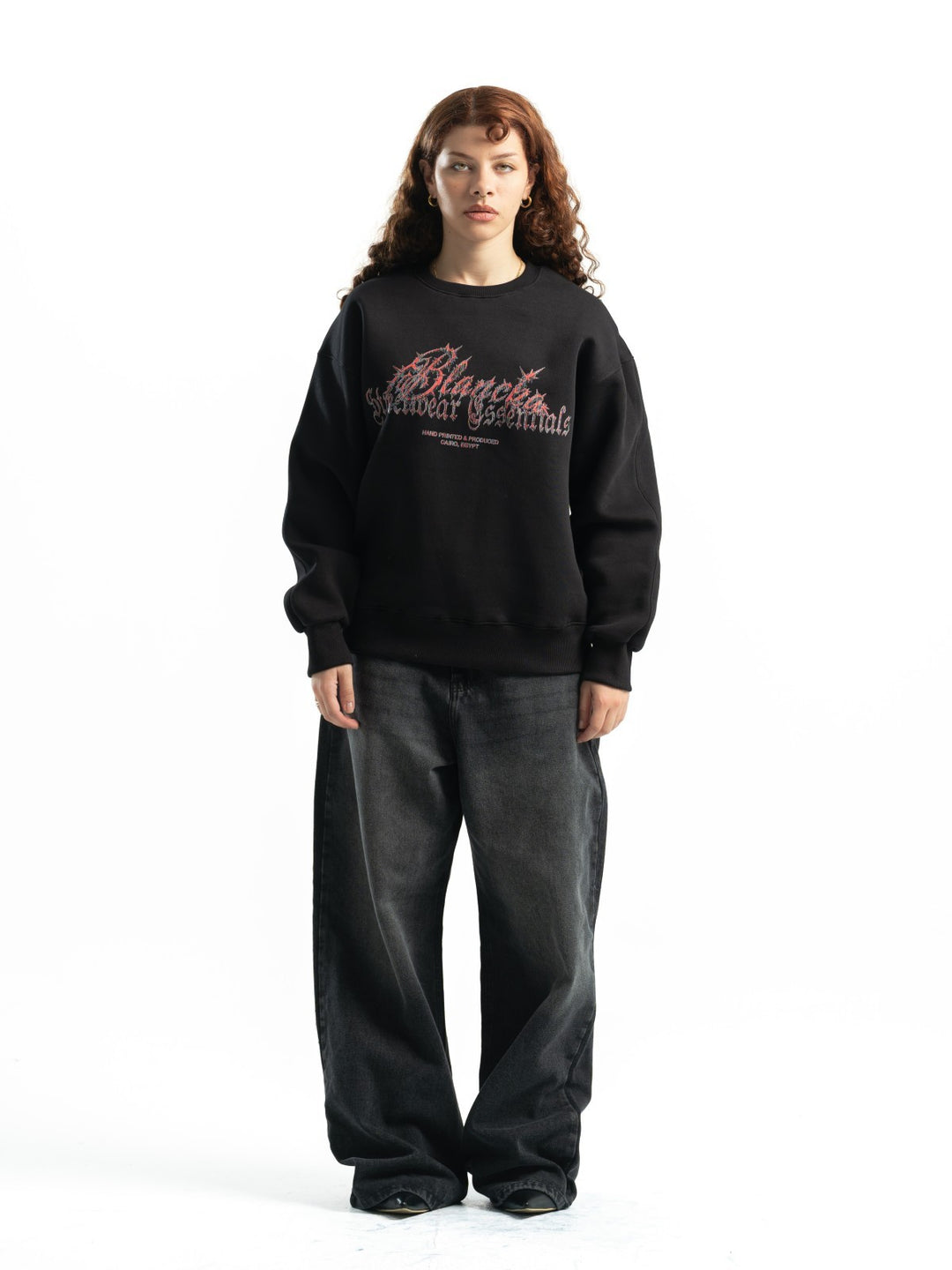 Female model wearing BLANCKA Thorns black oversized crewneck with thorn-inspired graphic