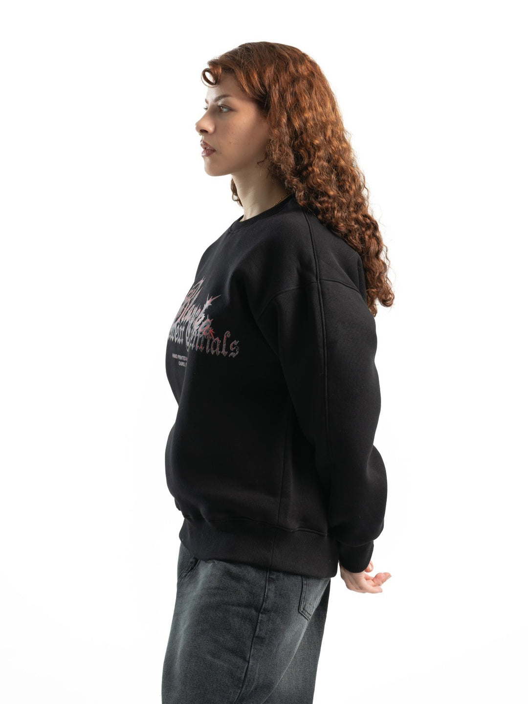 Female model wearing BLANCKA Thorns black oversized crewneck with thorn-inspired graphic
