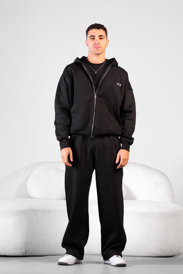 Unisex oversized zip hoodie set in charcoal grey with wide-leg sweatpants – BLANCKA Winter 2025.
