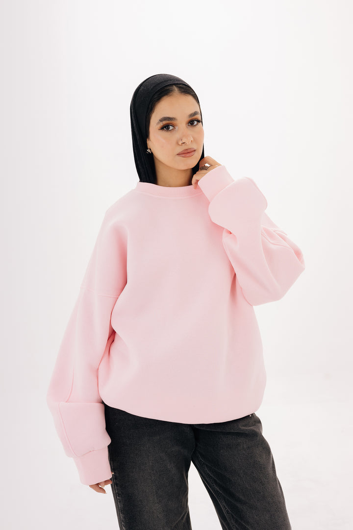Model wearing pink oversized basic crewneck sweatshirt by Blancka

