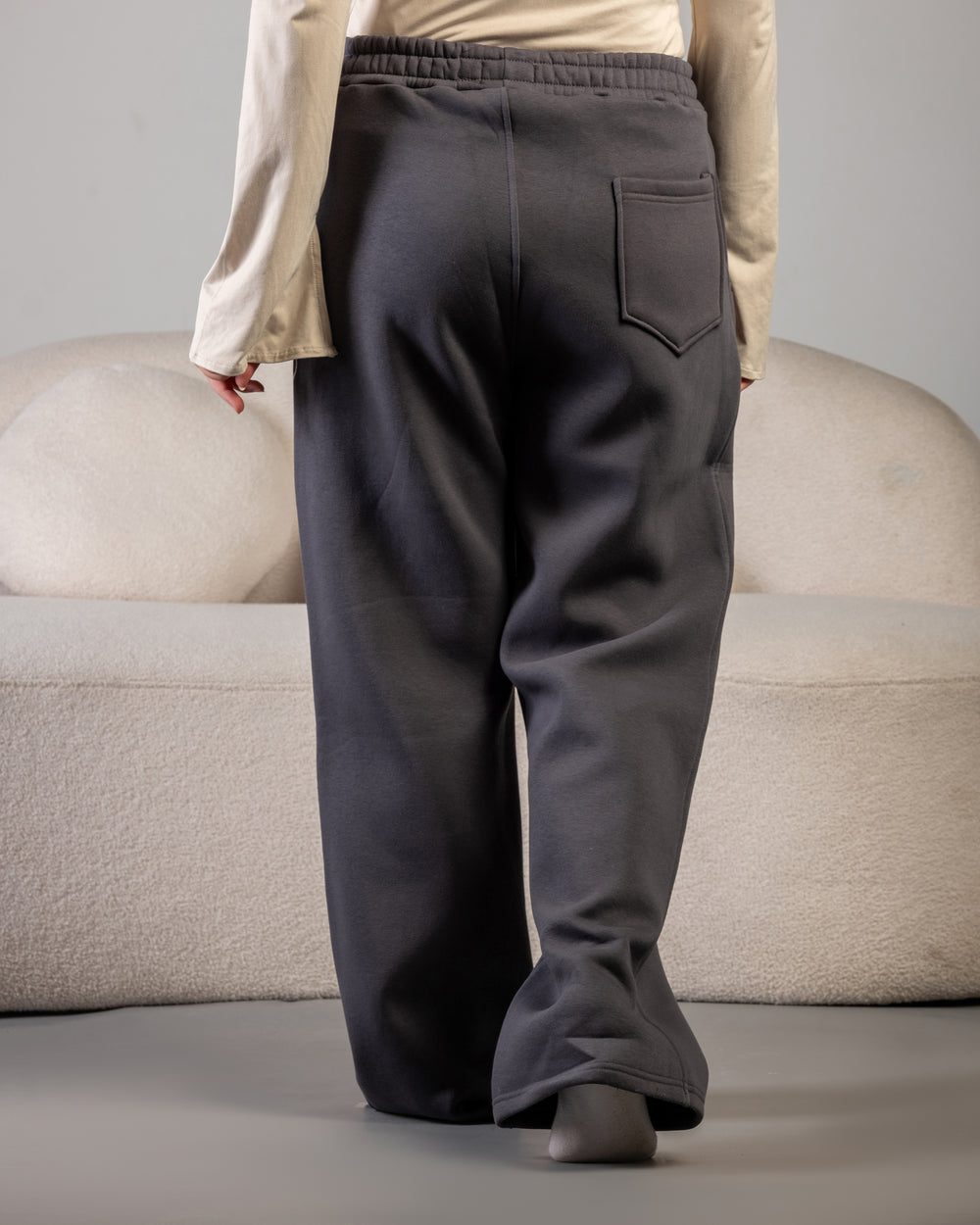 “Dark gray fleece sweatpants fabric texture – BLANCKA embroidery close-up”